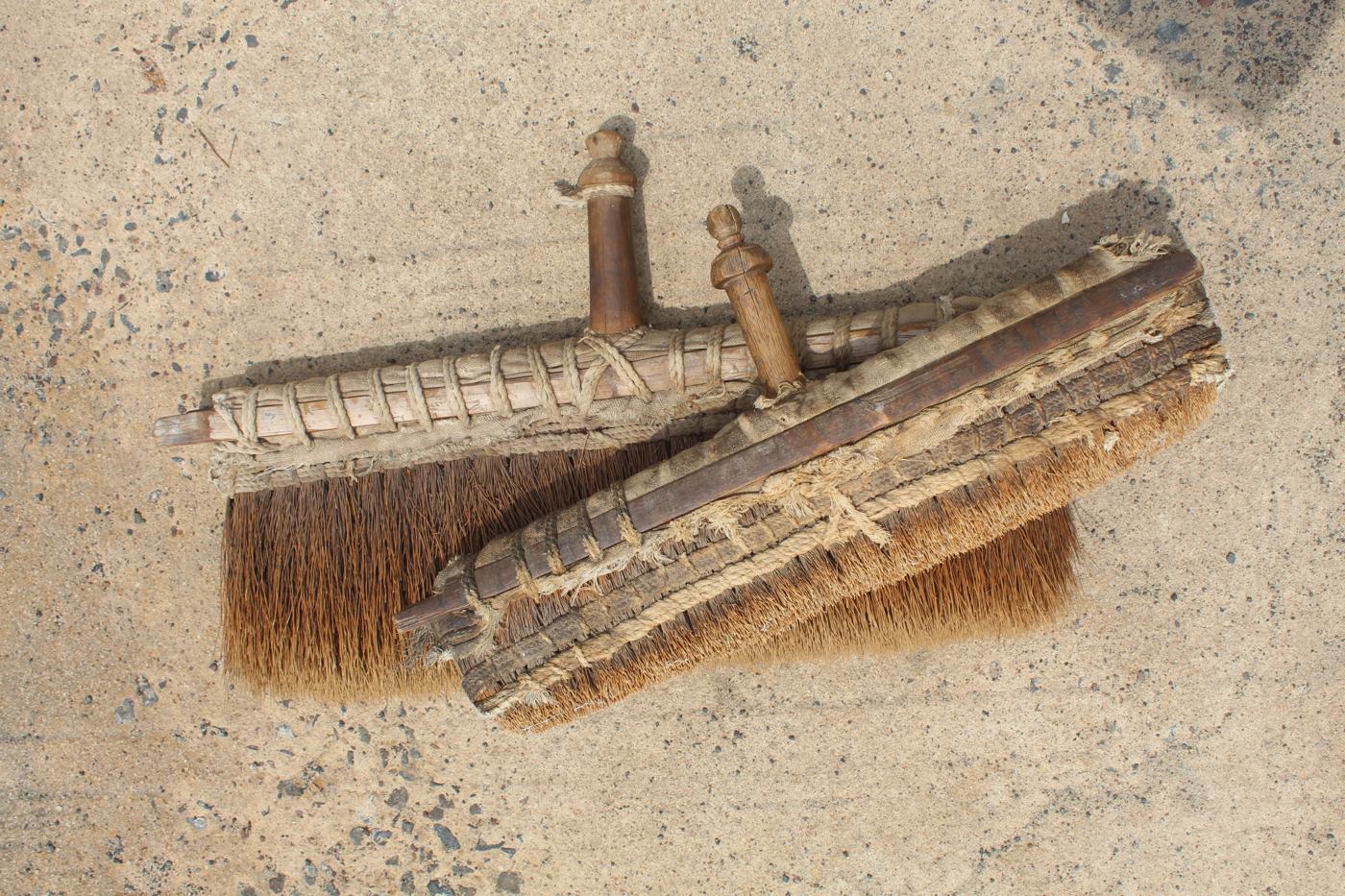 Traditional brushes used for sizing the warp
